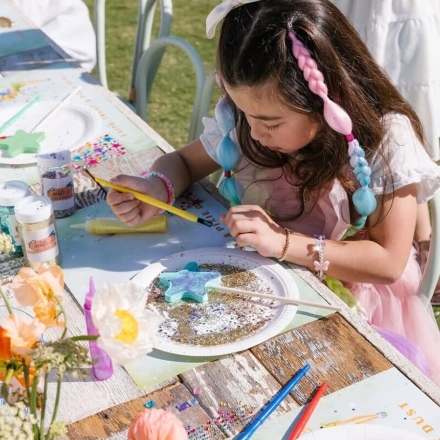 A child painting a star-shaped craft at a Party Beans celebration